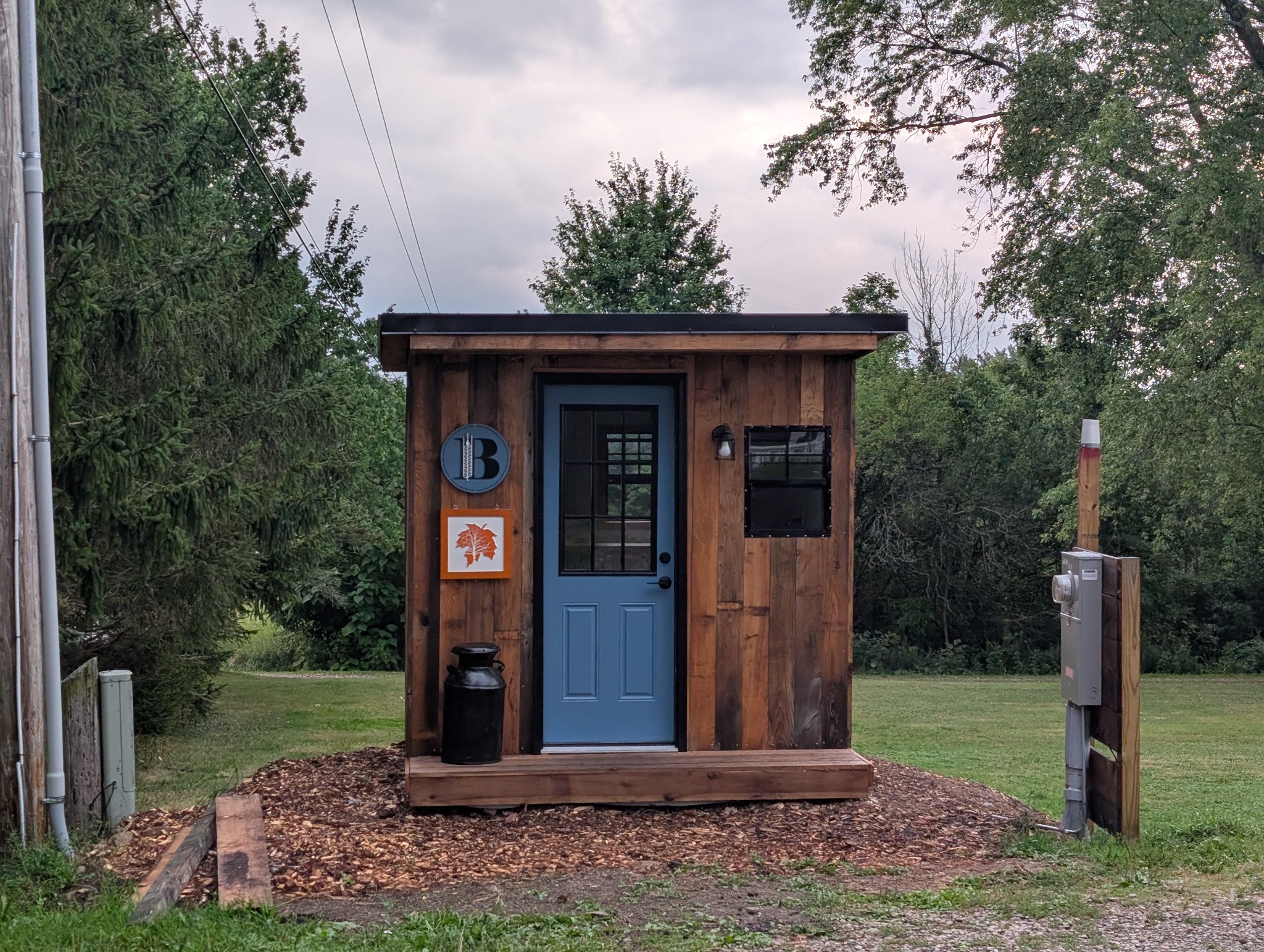 The Butterburr farm stand with its blue door and wood siding